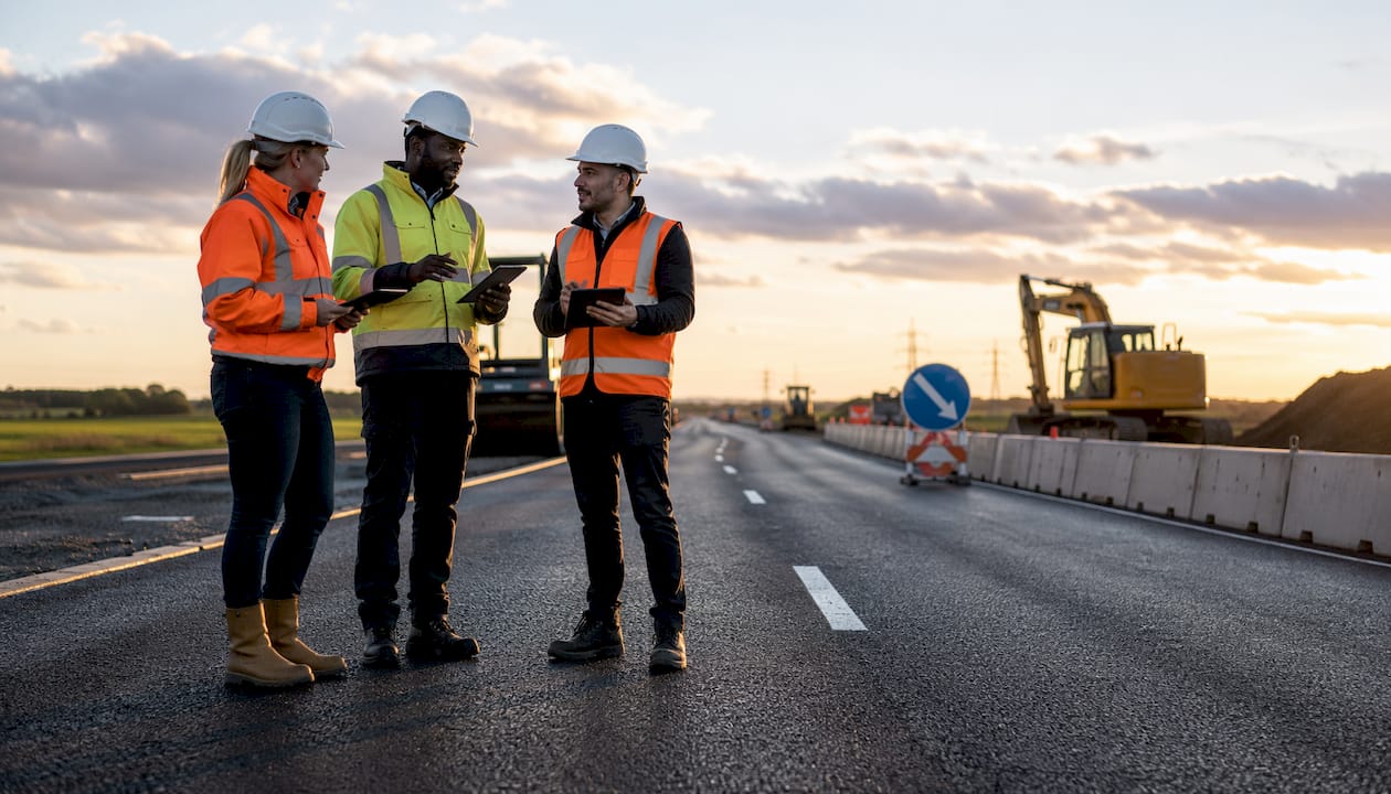 Team inspecting new UK highway construction outdoors
