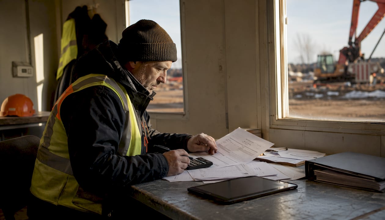 Accountant reviewing insurance checklist on site table
