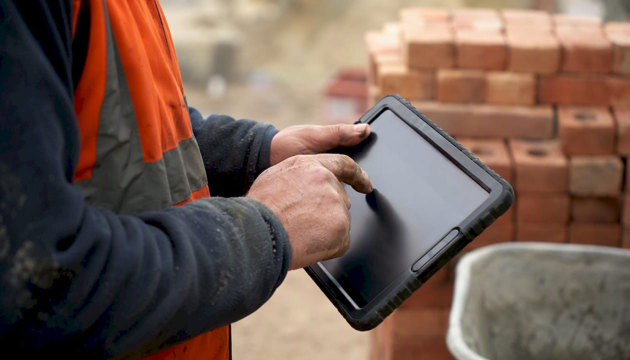 Site manager hands entering payment on tablet