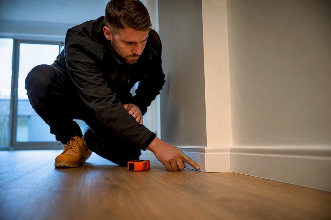 Inspector examining a home finishing defect