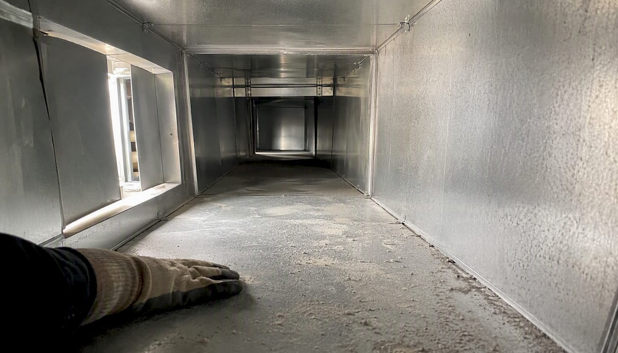 Interior commercial air duct with dust buildup
