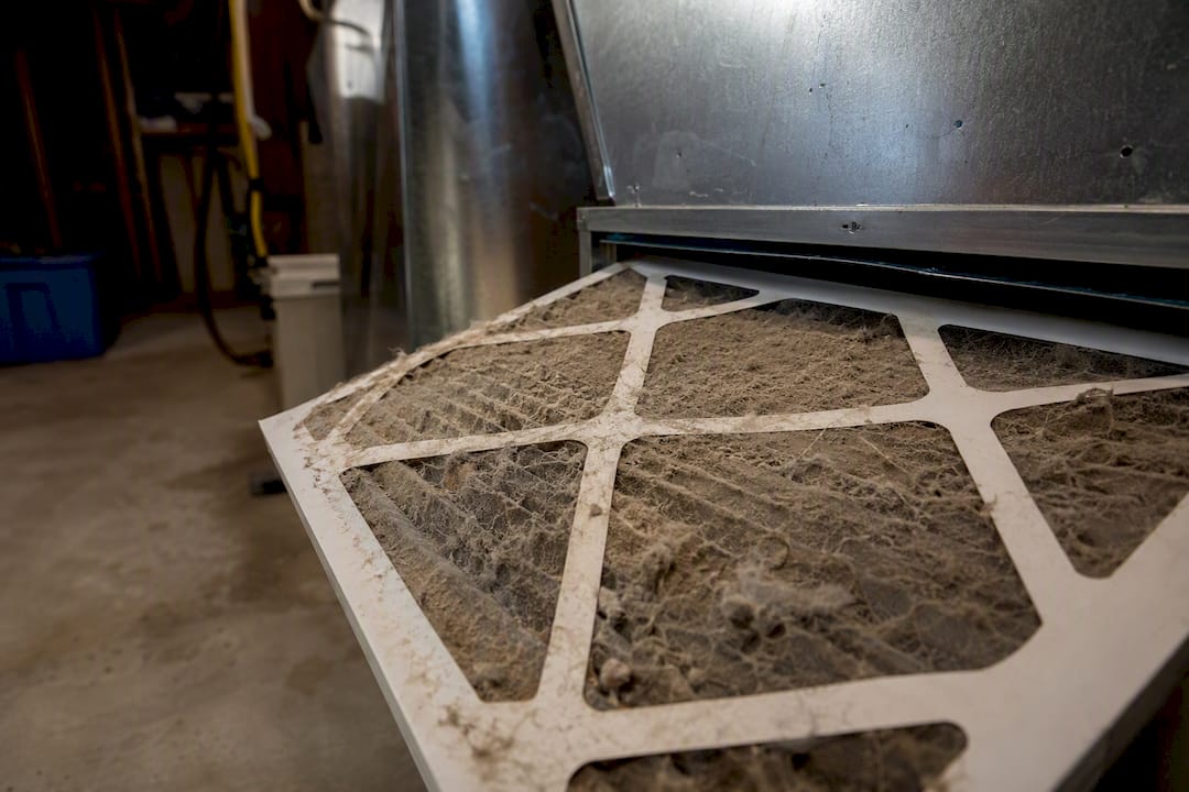 Clogged dusty HVAC air filter close-up