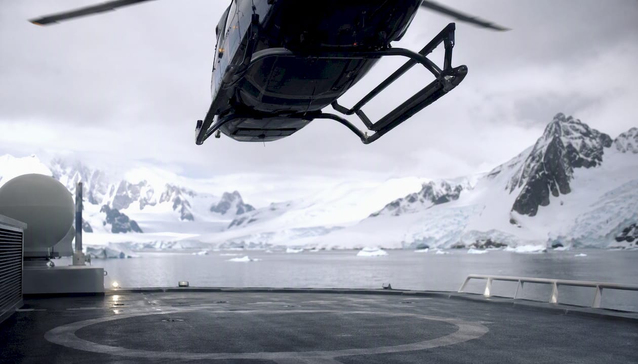 Helicopter landing on polar yacht helipad for medevac
