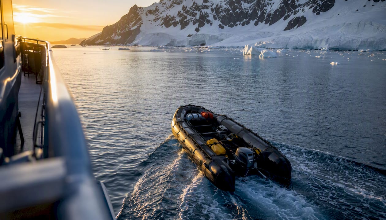 Zodiac boat in morning light near icy shore