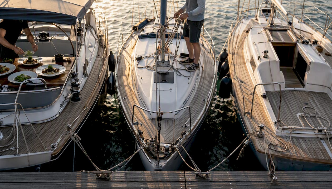 Three yachts representing charter types in marina