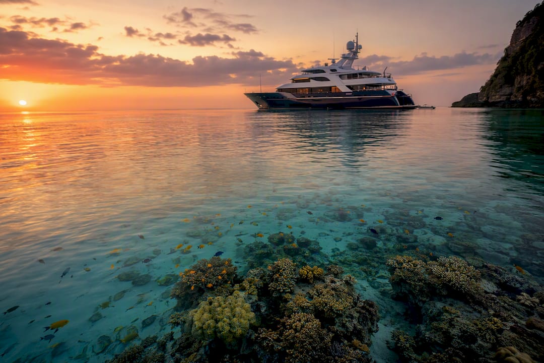 Luxury yacht anchored at remote reef site