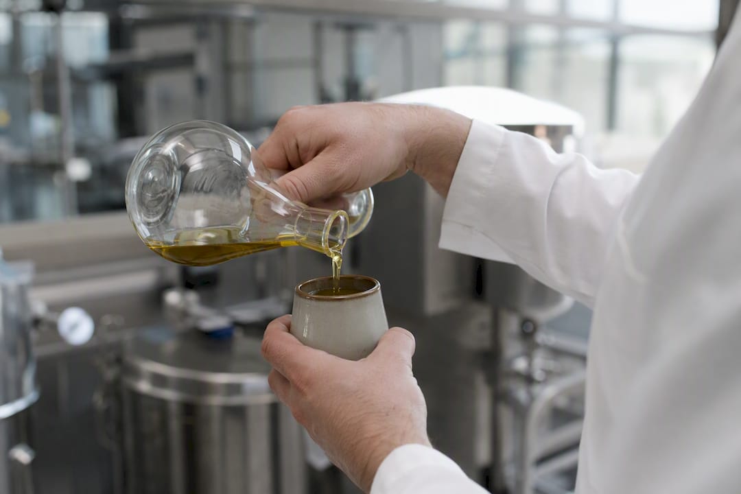 Pouring hemp oil in lab setting