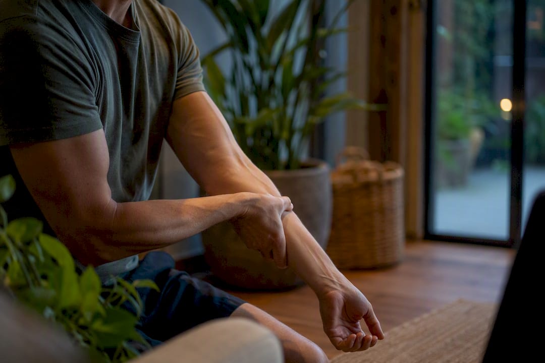 Hands massaging forearm muscles