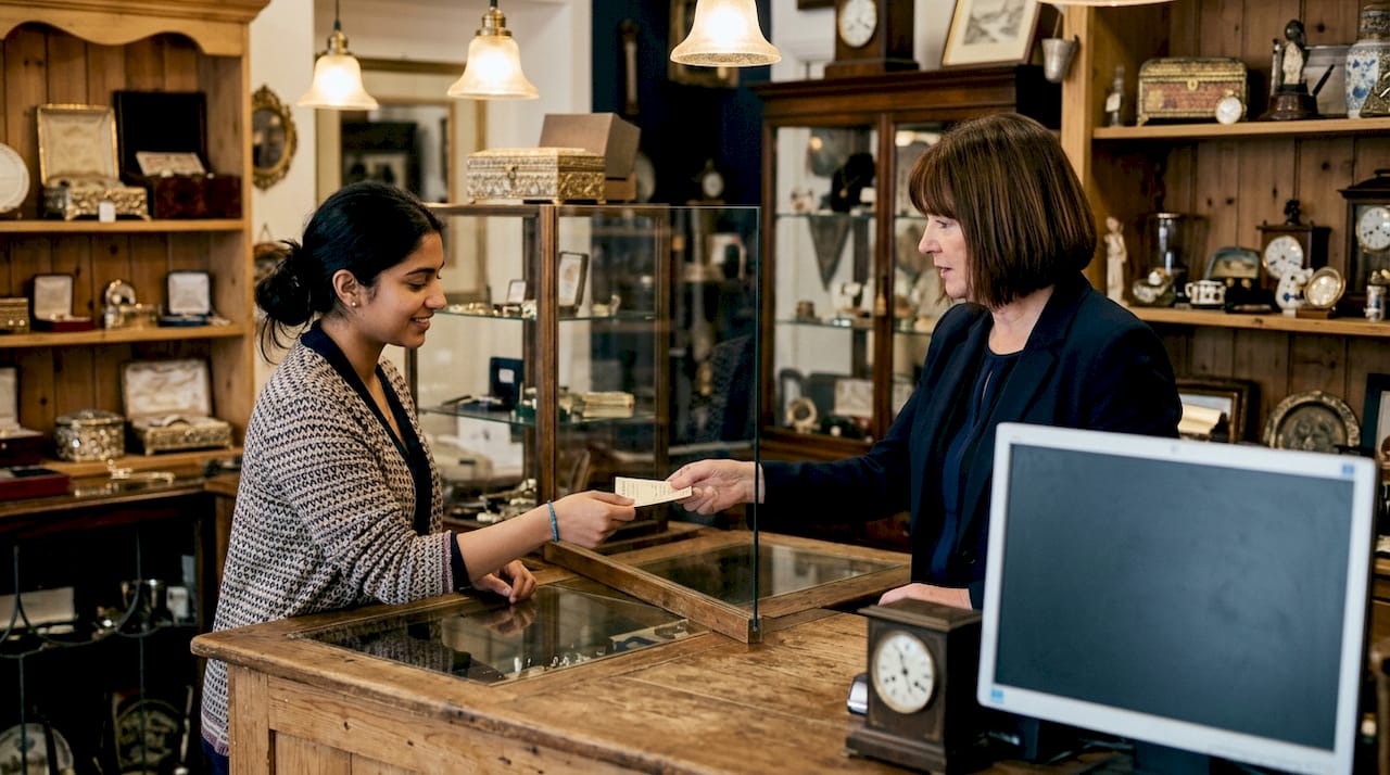 Customer redeeming pawn ticket at store counter
