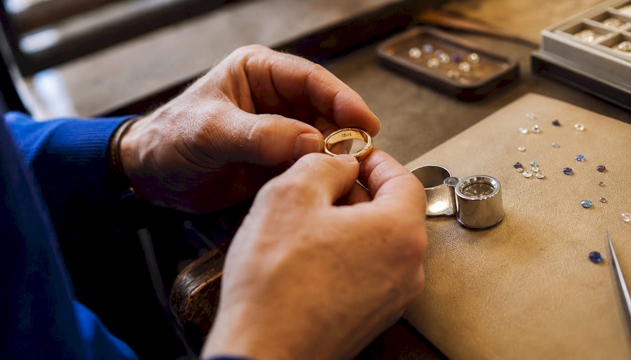Close-up of gold ring with 18ct mark