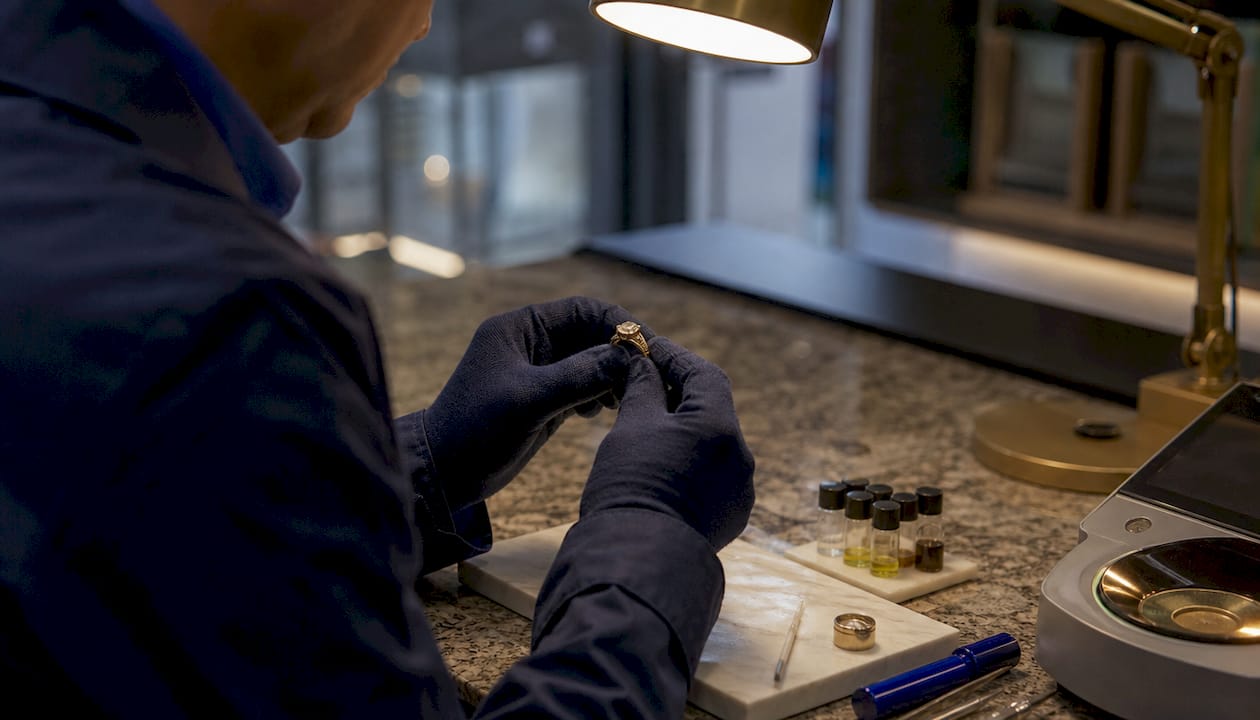 Jeweller testing gold ring purity close-up