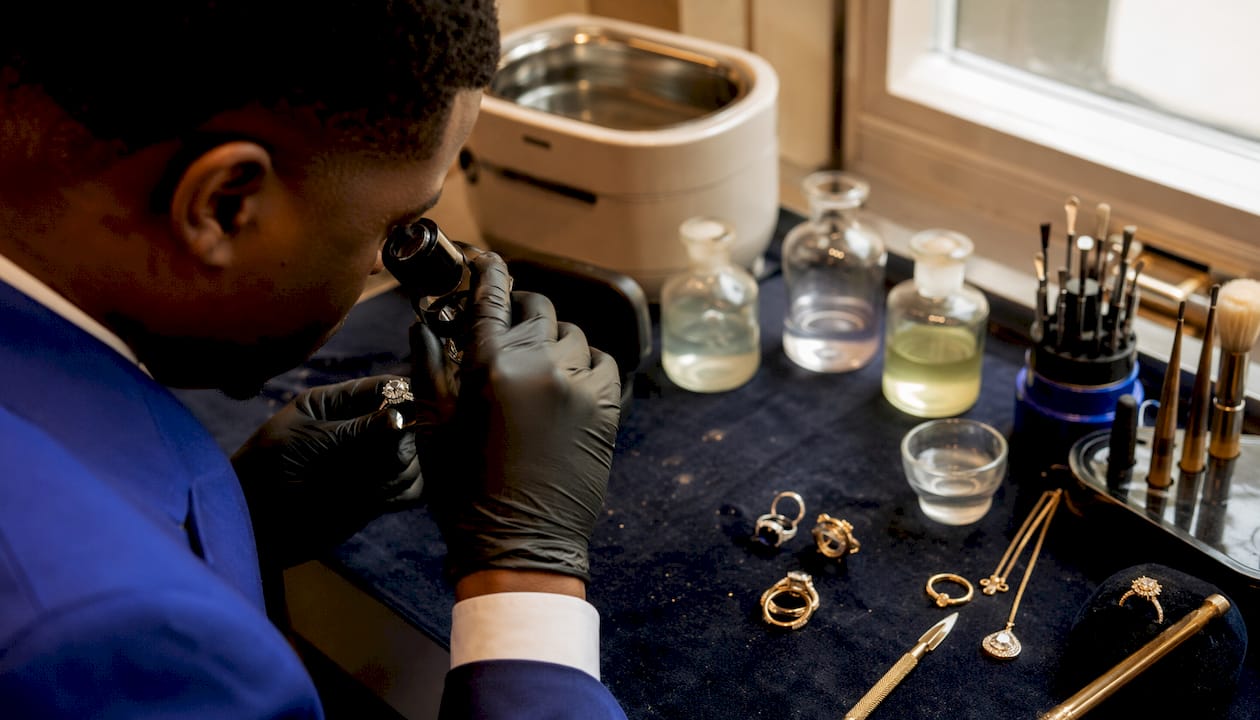 Jeweller inspecting ring in workshop