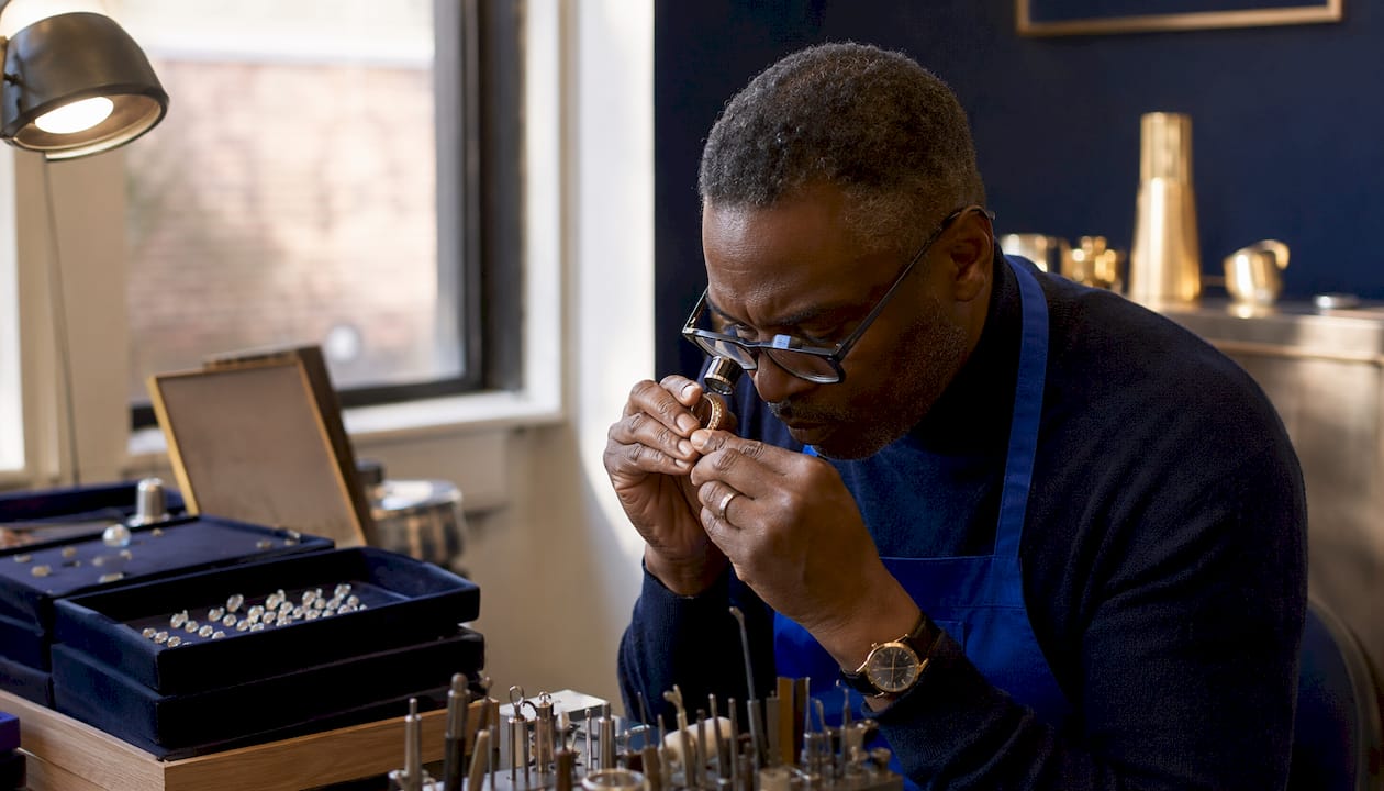 Jeweller examining gold ring repair closely