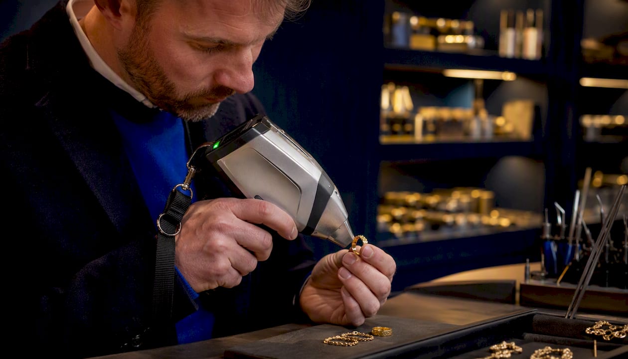 Jeweller testing gold purity with XRF device