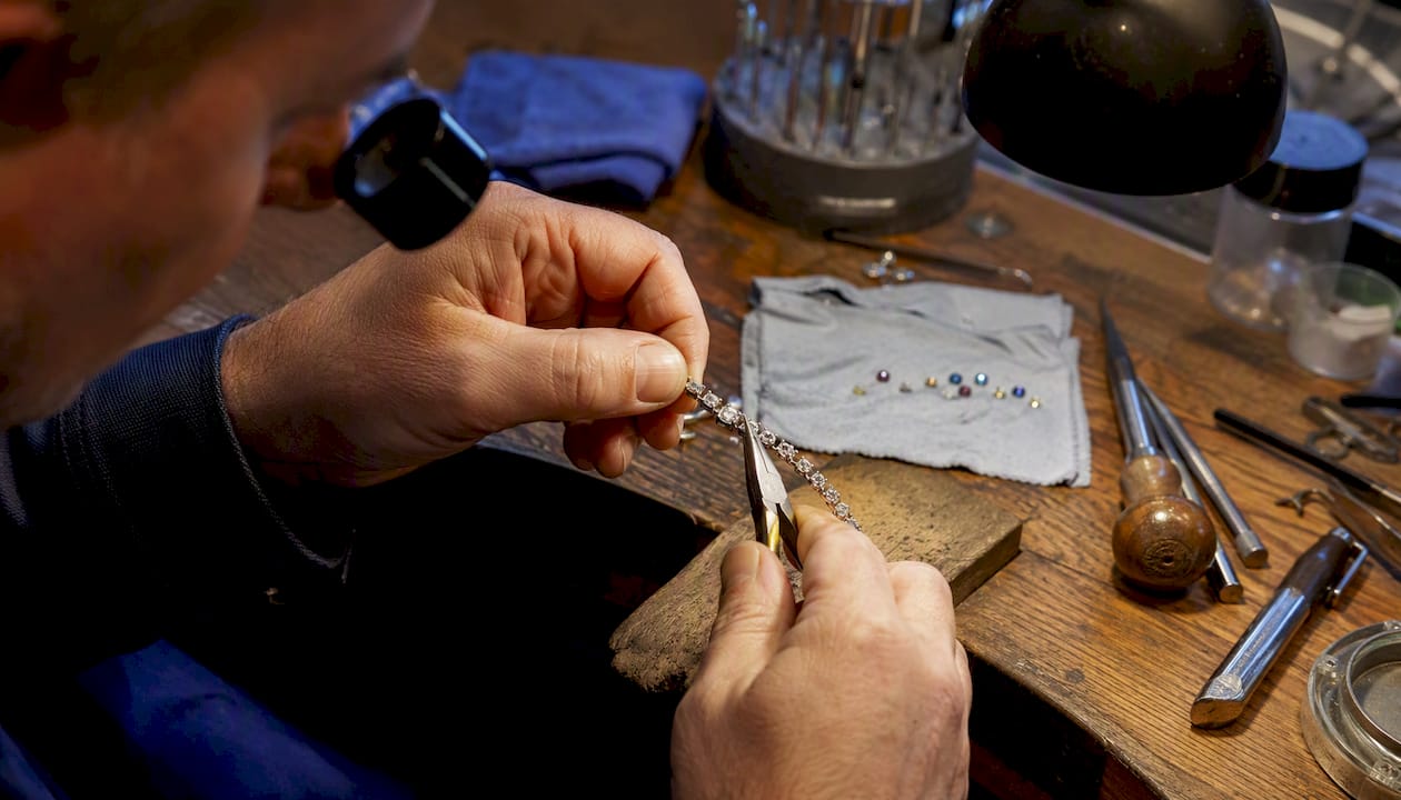 Jeweller repairing gold ring