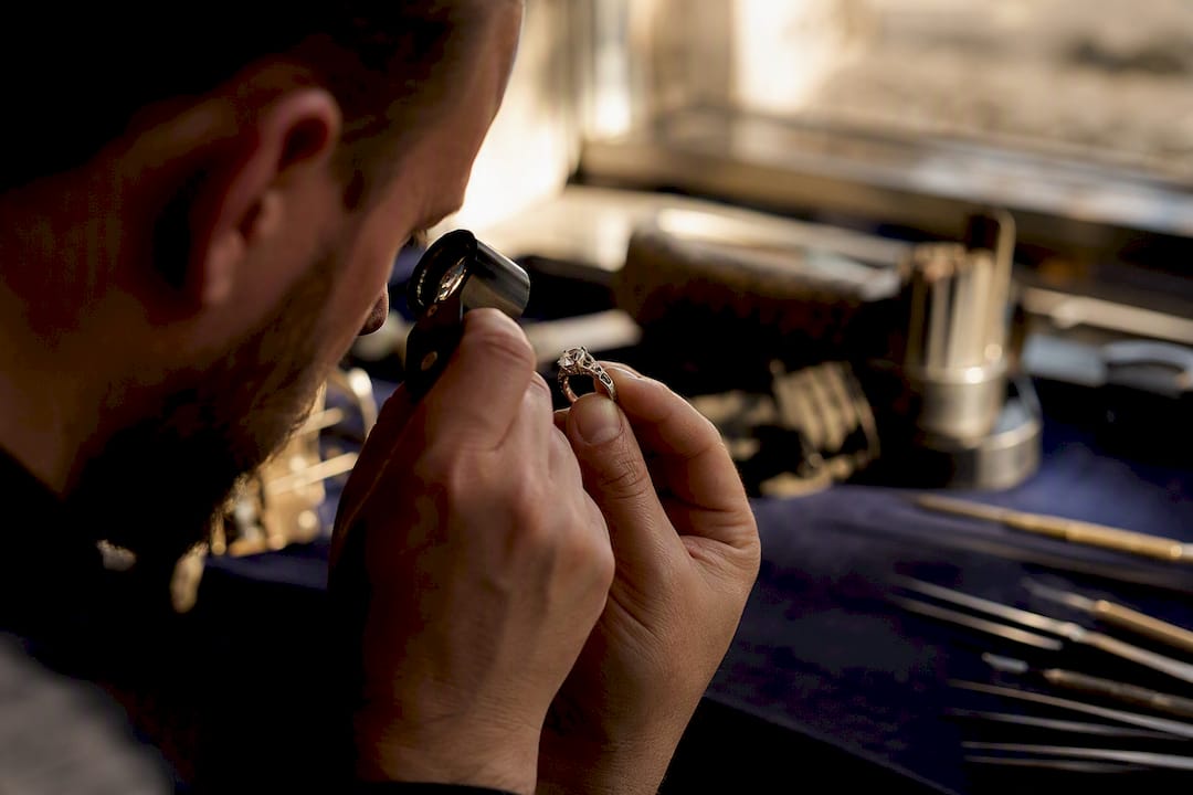 Jeweller examining diamond culet and girdle