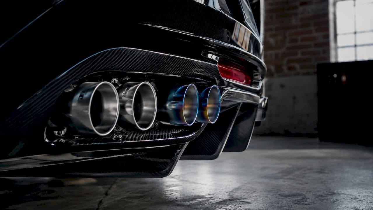 Close-up contrasting titanium and stainless steel exhaust tips