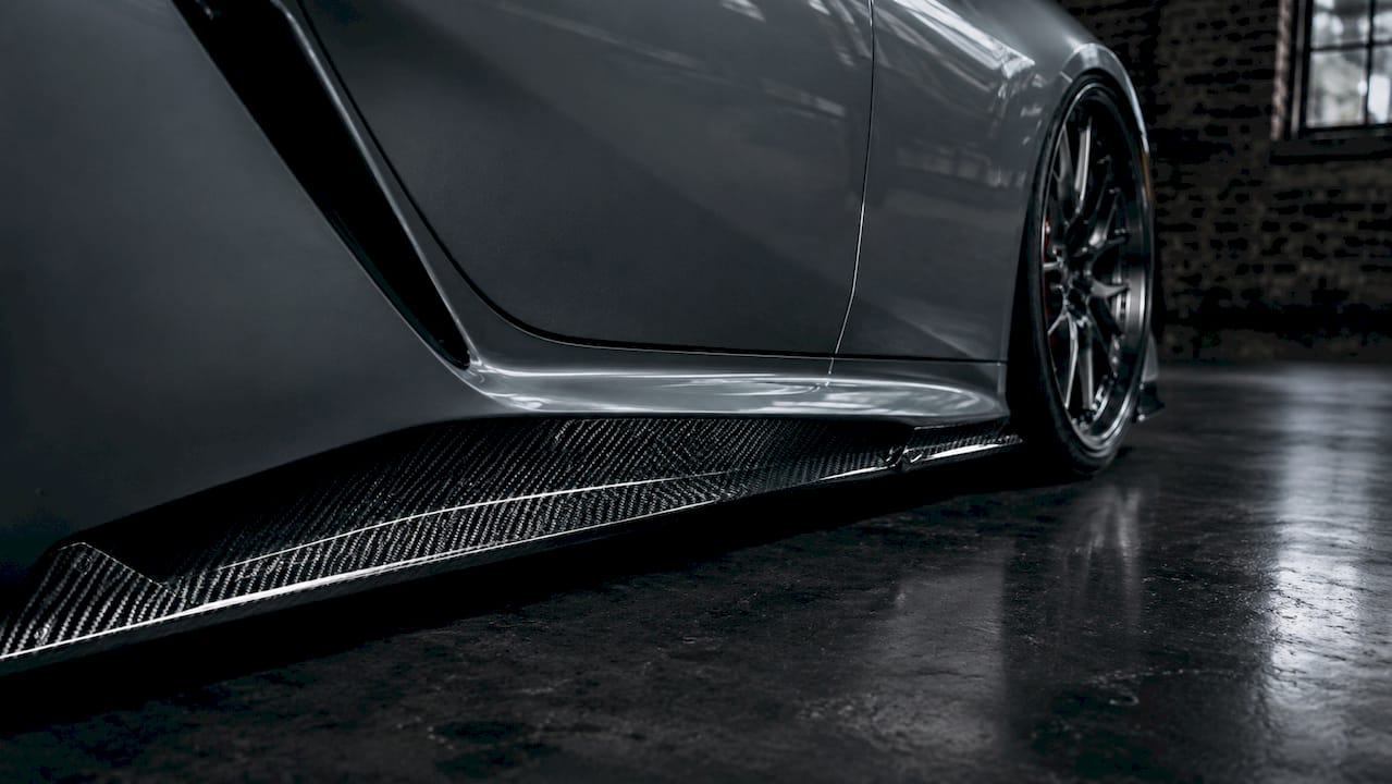 Close-up view of carbon fiber side rockers on Lexus LC500