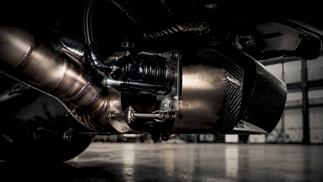 Close-up of E6 Motorsports exhaust valve actuator and carbon fiber parts