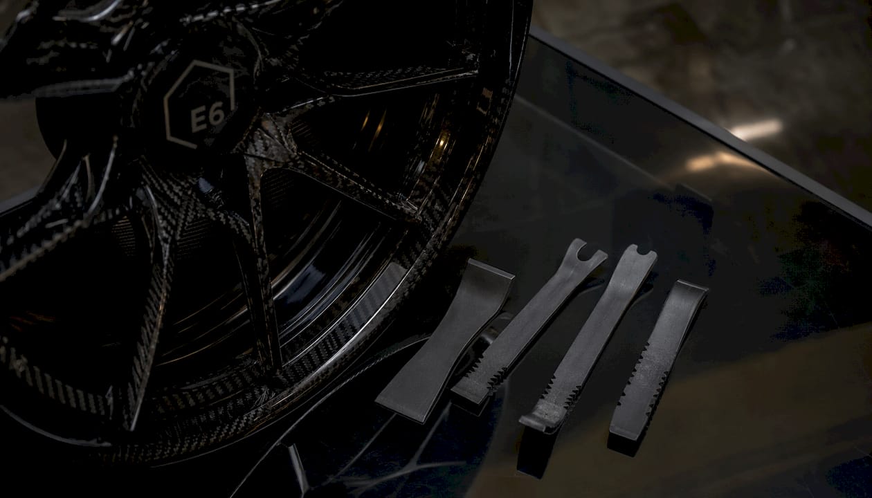Plastic pry tools beside forged carbon wheel