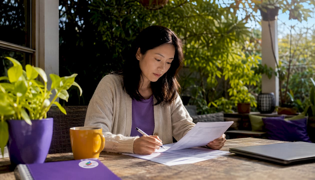 Homebuyer reviewing mortgage rates at kitchen table