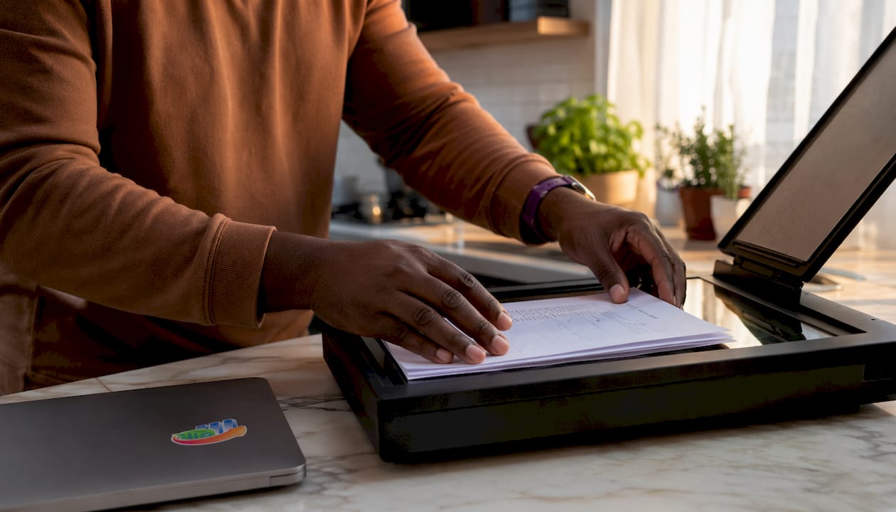 Hands scanning mortgage documents in home office