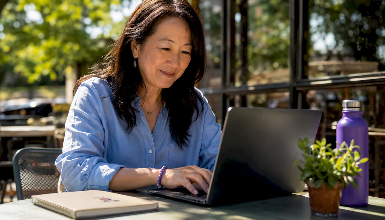 Woman emailing mortgage document confirmation in office