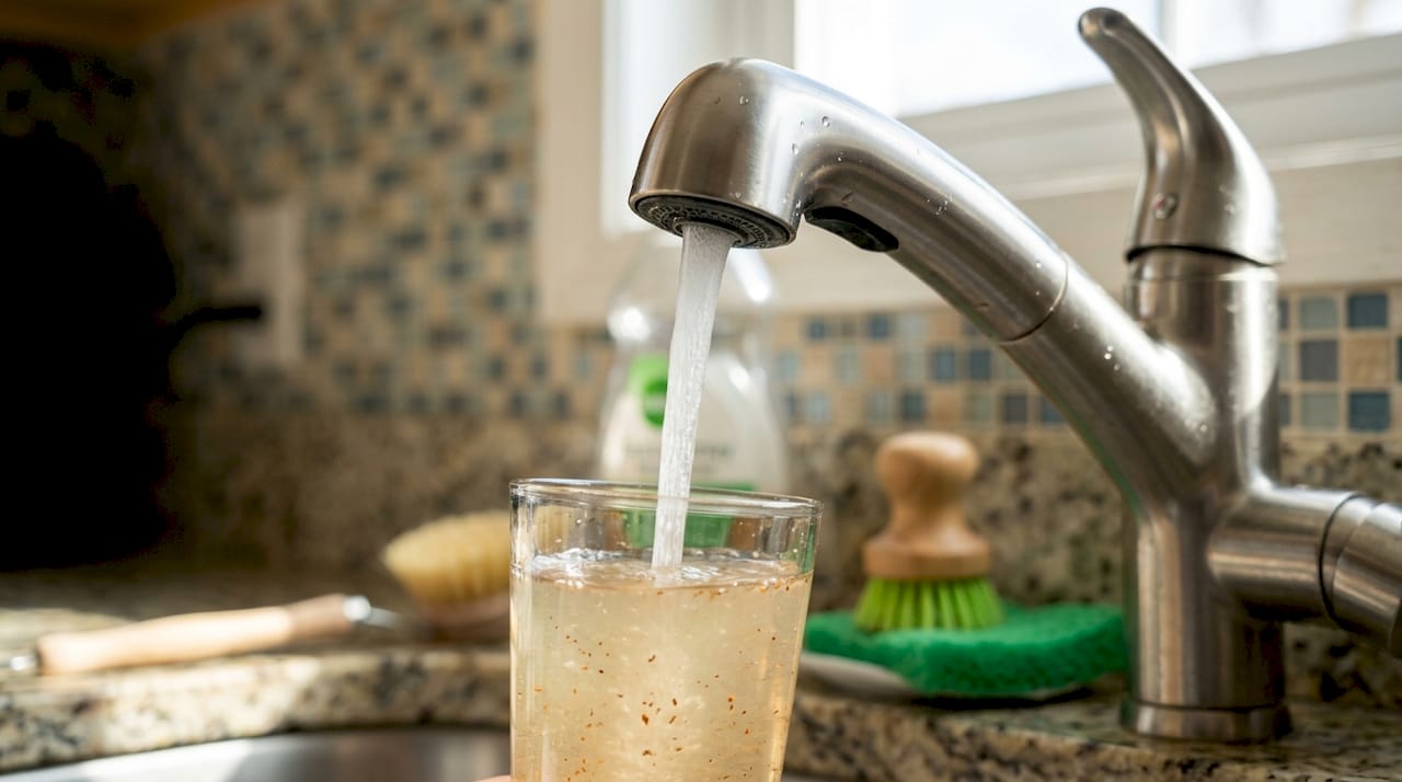 Rust and sediment in tap water close-up