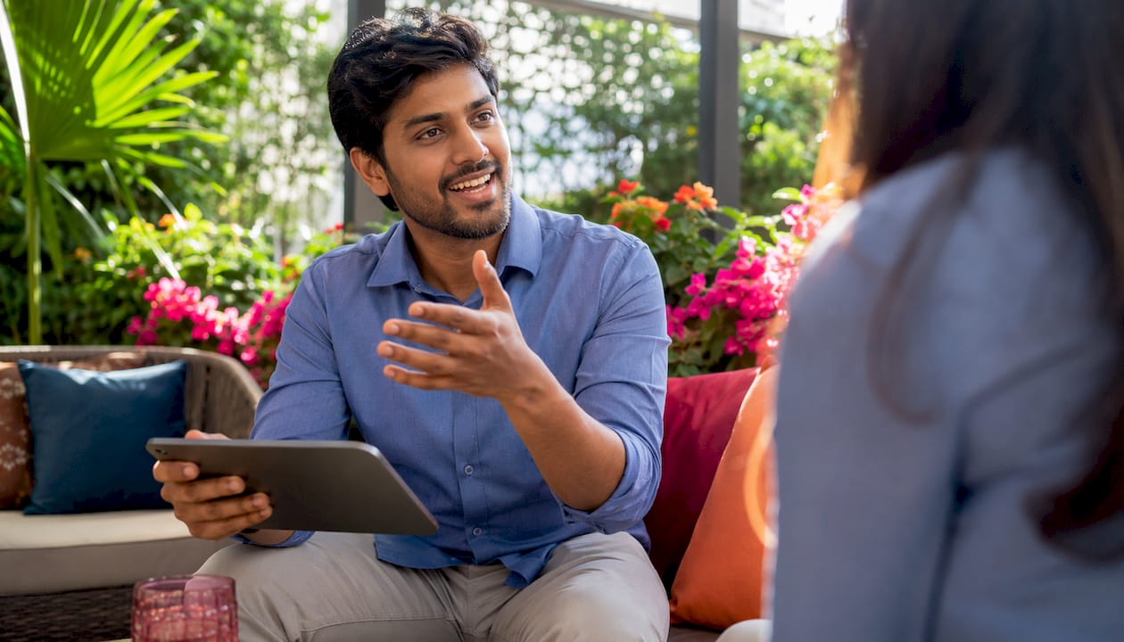 Man explaining translation quality on tablet