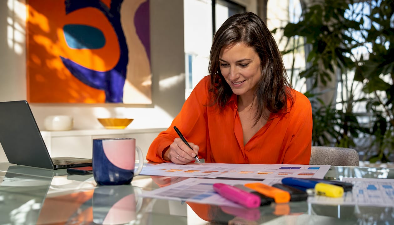 Woman evaluating translation error reports at desk