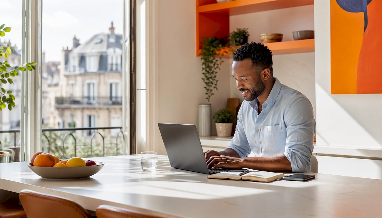 Translator typing on laptop in home office