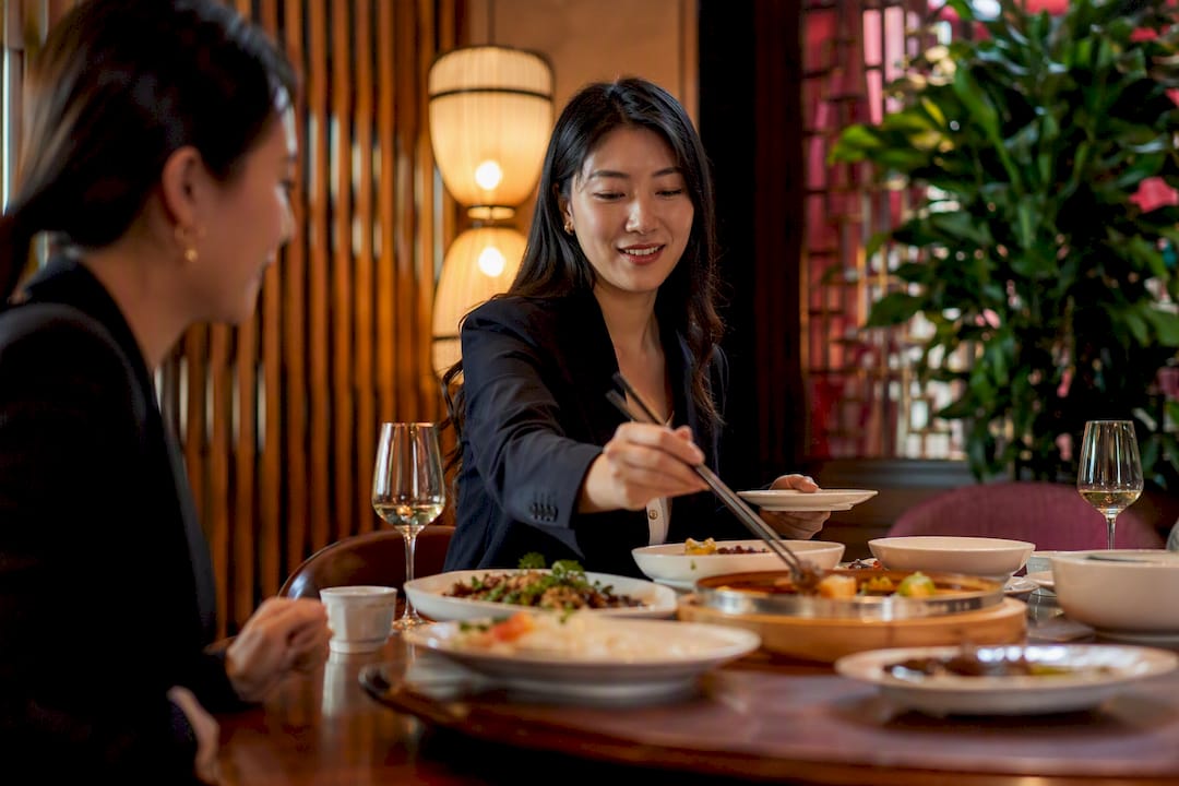 Woman serving food at Chinese banquet table