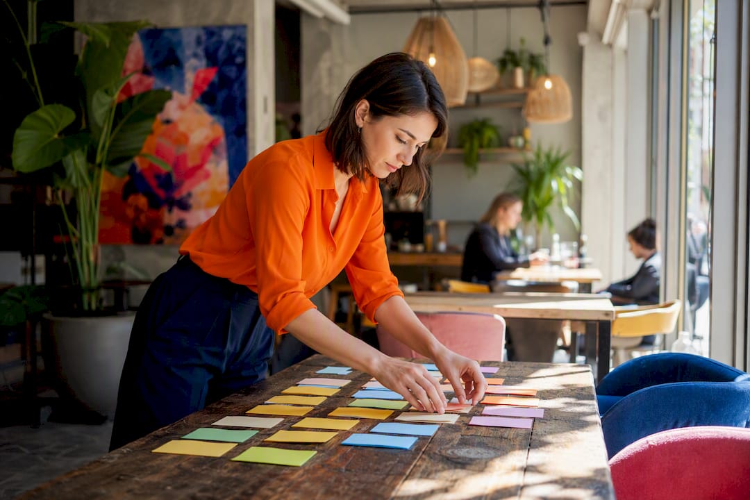Hands arranging colorful terminology cards on desk