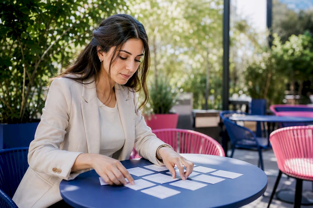 Hands arranging bilingual legal term cards