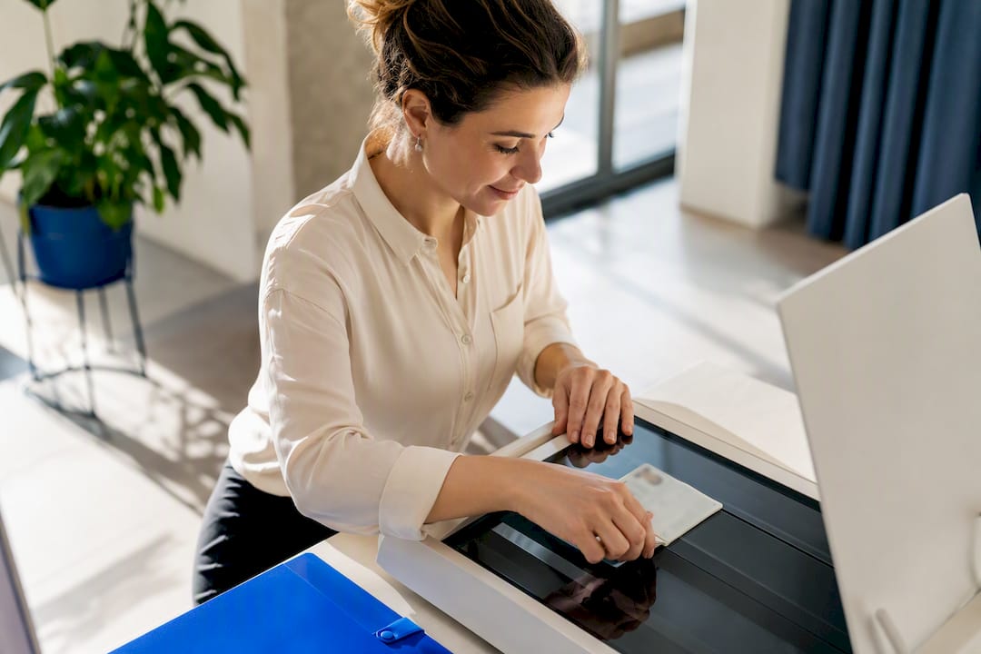 Specialist aligning passport for scanning
