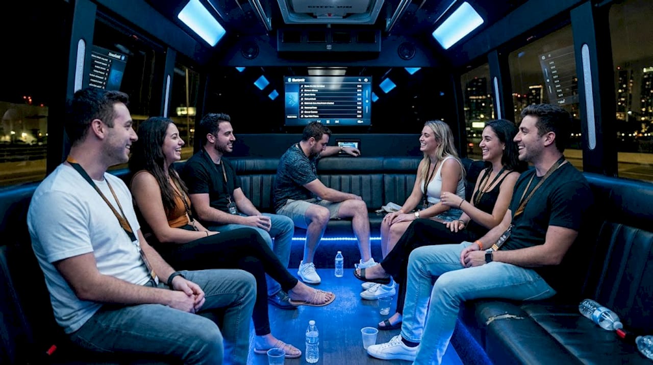 Friends inside Miami party bus at night