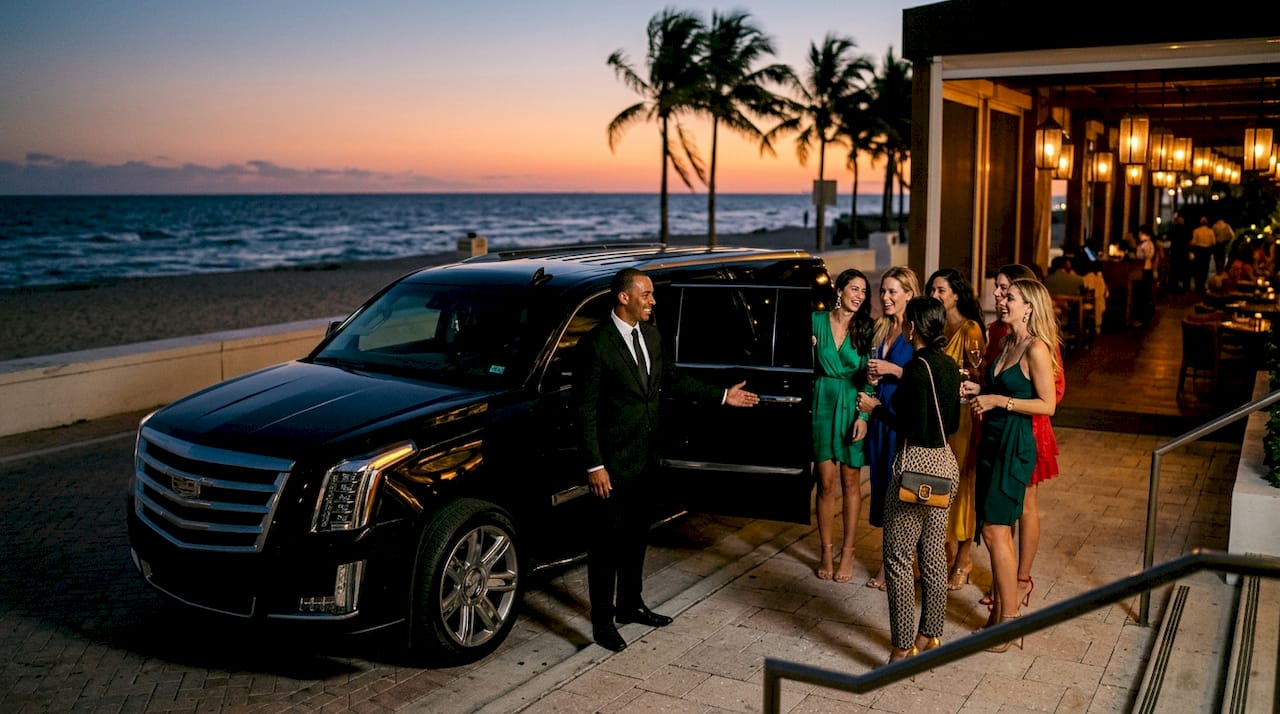 Group entering Cadillac Escalade limo in Miami
