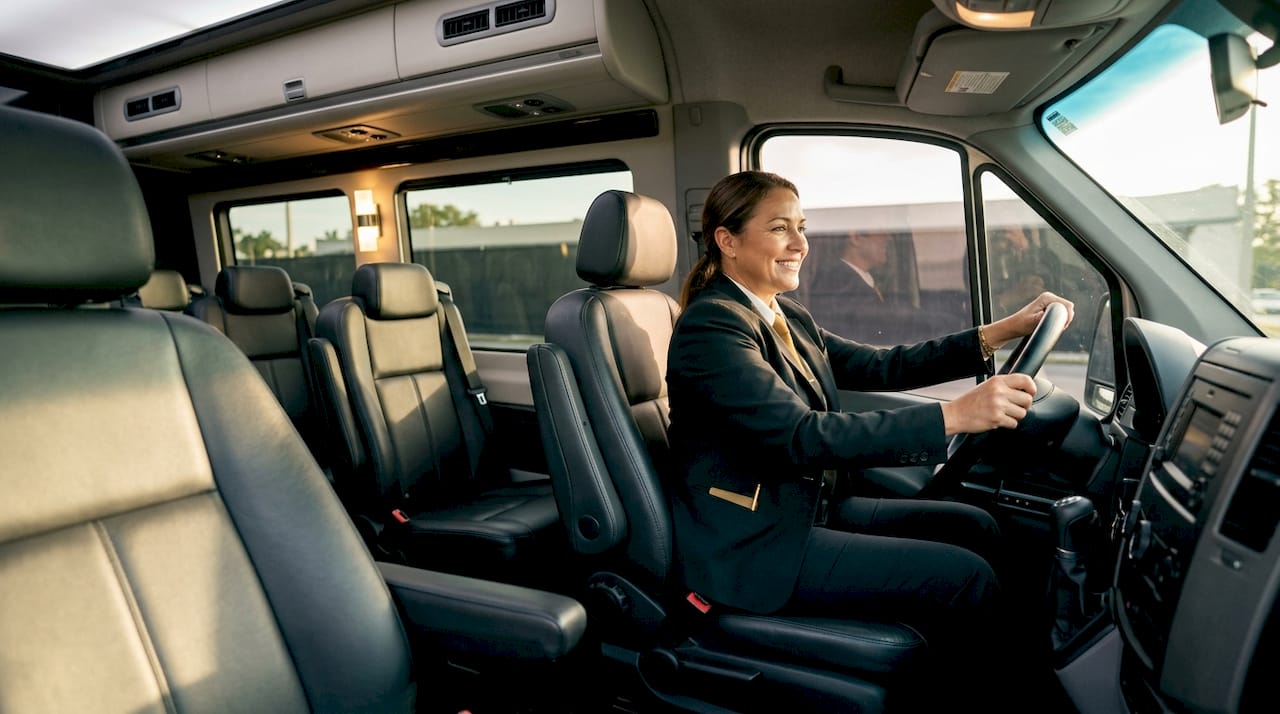 Chauffeur driving luxury minibus interior view