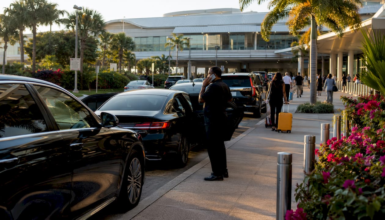Ride-share vehicles and passengers at airport pickup zone