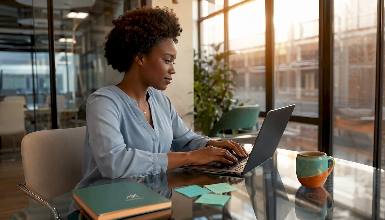 Marketing coordinator typing at home desk