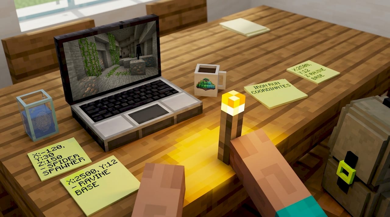 Hands placing torch next to Minecraft laptop