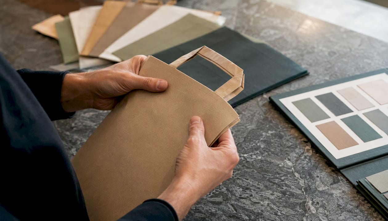 Hands inspecting paper bag sample