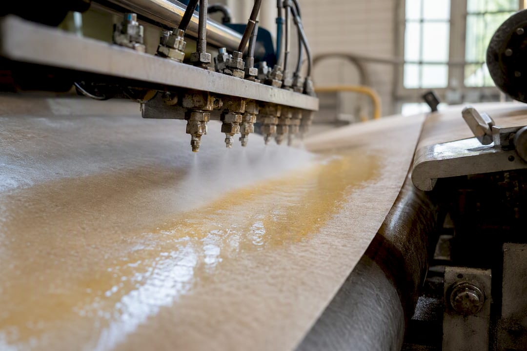 Wet strength resin applied to paper fibers