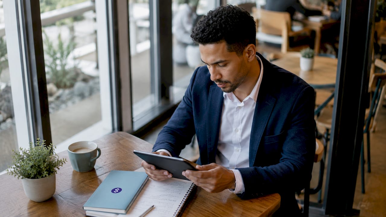 Man using tablet for international transfer