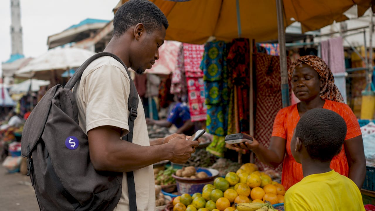 Urban African market scene with mobile payment