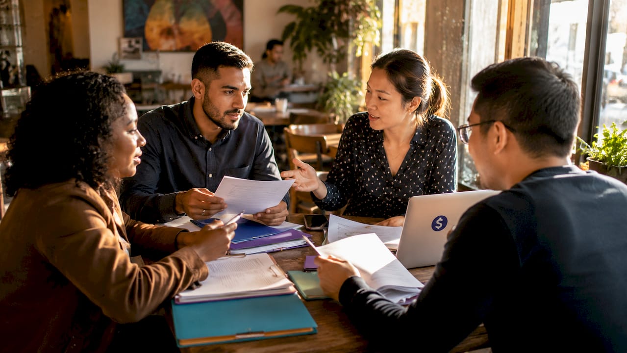 Remittance specialists collaborating paperwork