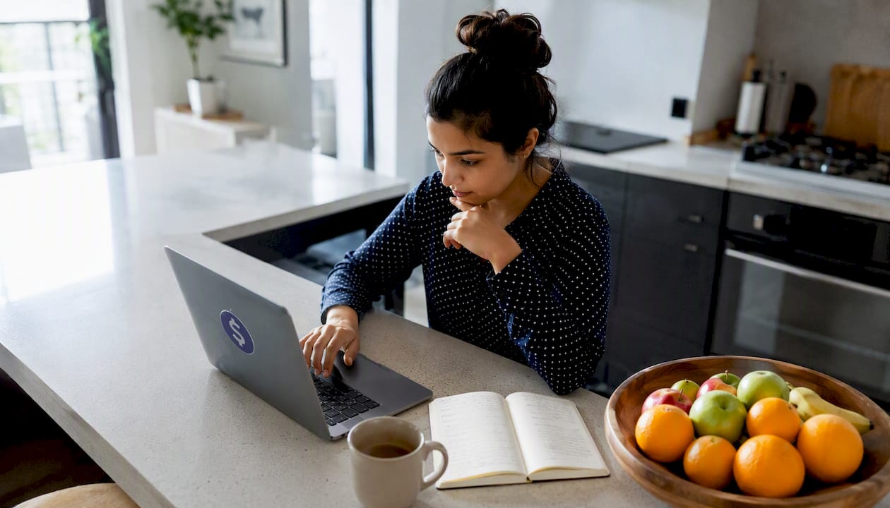 Woman comparing money transfer rates on laptop