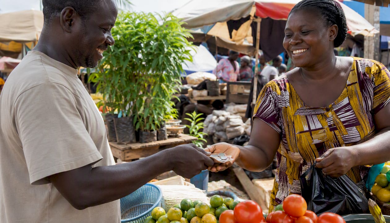 Hands exchanging cash and smartphone in Ghana street