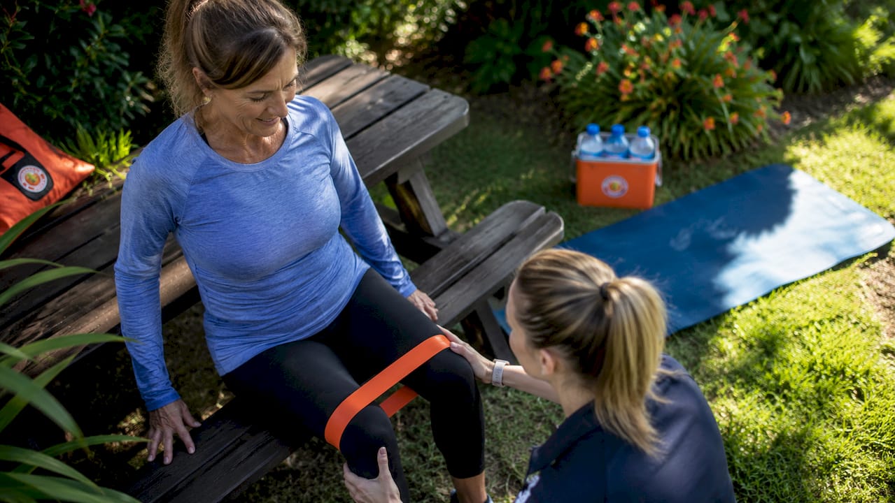 Patient performing knee prehab exercises with therapist