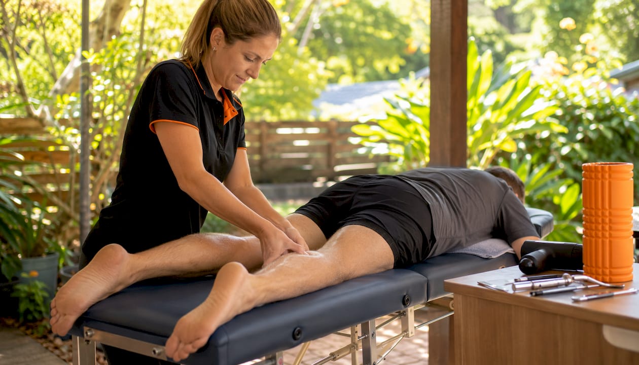Physiotherapist performing Thompson calf squeeze test